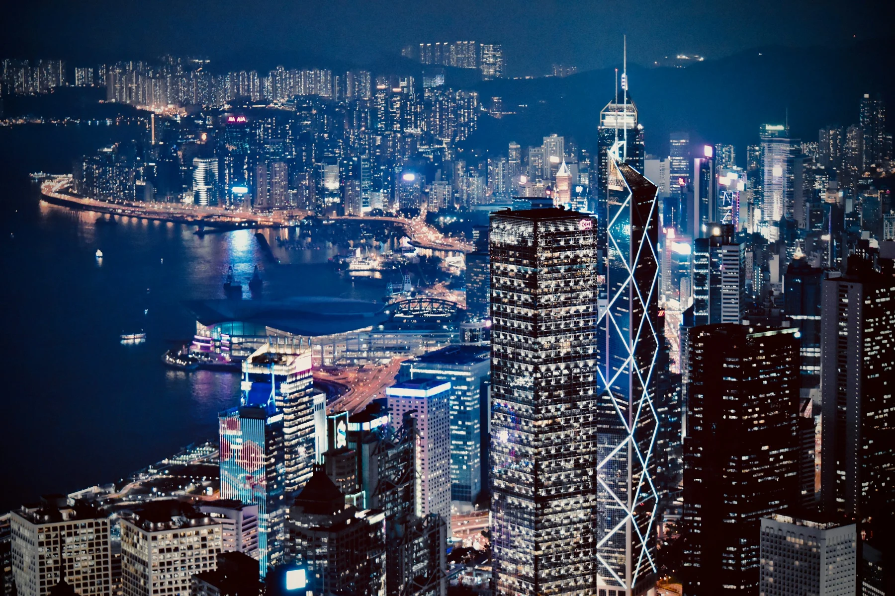Hong Kong’s illuminated business district and Victoria Harbour at night